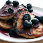 Golden Cornmeal Pancakes Drizzled with Blueberry Syrup Bliss